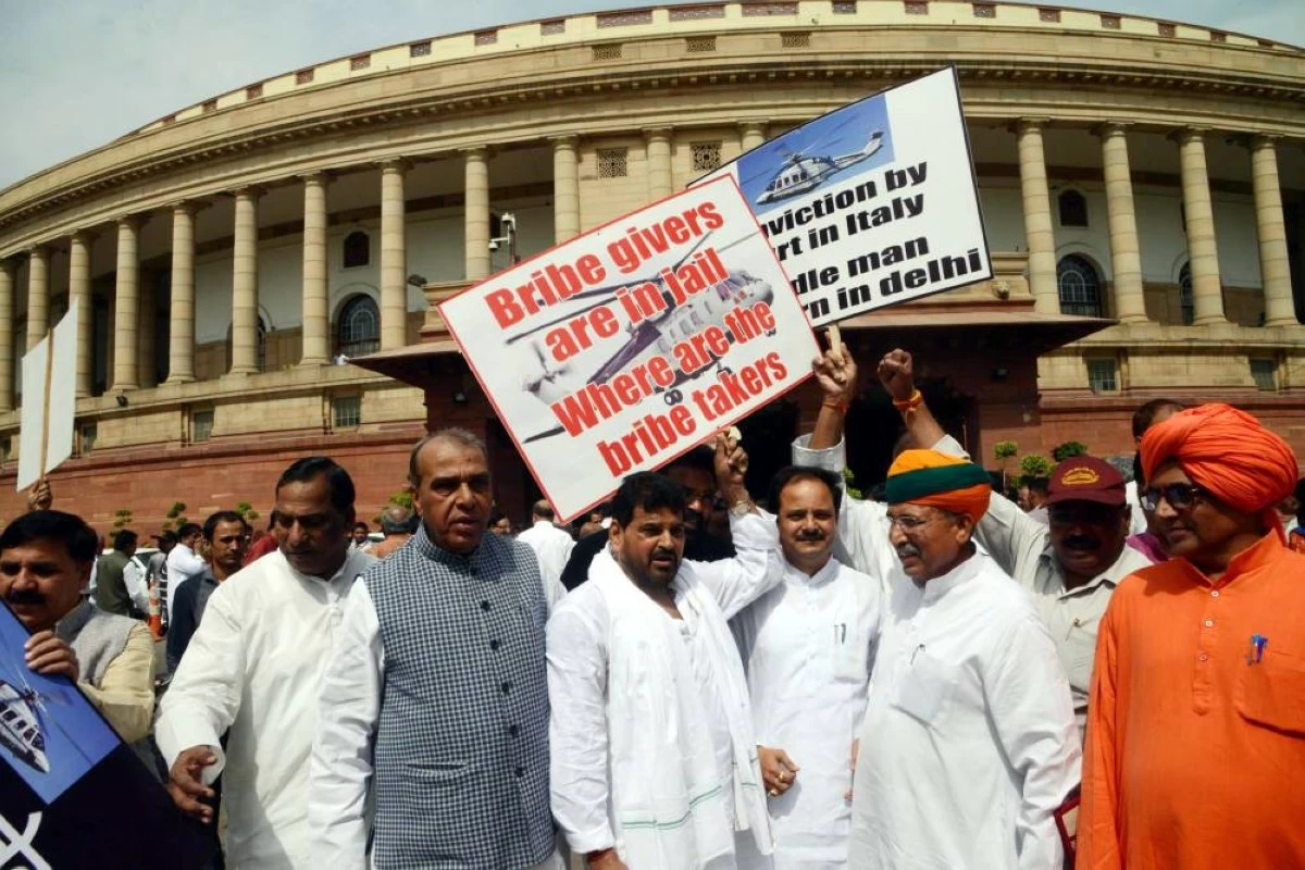 BJP MPs protest against AgustaWestland Scam at Parliament during the Budget Session on May 6, 2016 in New Delhi, India. Mounting attack on Congress, Defence Minister Manohar Parrikar said in Lok Sabha that the previous UPA government had done everything to help AgustaWestland bag the chopper deal and asserted that the main beneficiaries of the kickbacks will be tracked so that maybe we can do what we could not do in Bofors. (Photo by Hindustan Times via Getty Images)