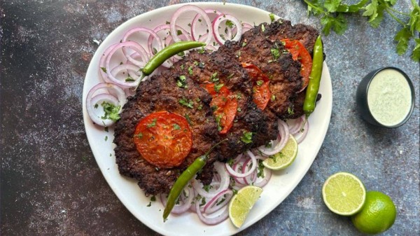 Chapli Kebab: Flat, spicy and flavourful kebabs prepared with chicken, tomato and herbs to enjoy the robust flavours. (Photo credit: Pinterest)
