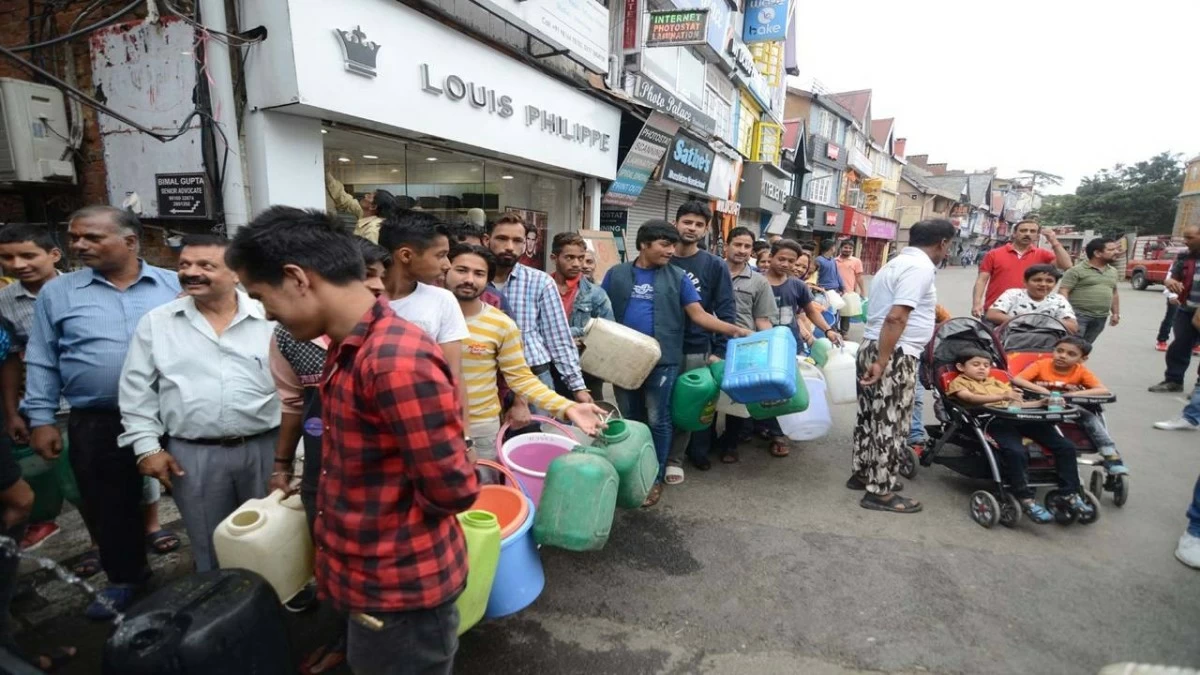 During the water crisis in Shimla town, local residents stand in the long queue with empty containers to fill water from the water tanker on Mall Road on May 27, 2018 in Shimla. (Photo Credit: Deepak Sansta/Hindustan Times via Getty Images)