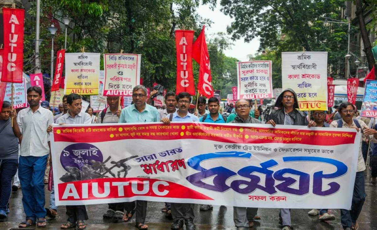 Members of All India United Trade Union Centre (AIUTUC) take part in a rally as part of the Bandh in Kolkata. Protesters also blocked train services at several stations, including Jadavpur, where members of Left-affiliated unions ignored police and sat on the tracks.  (Credit: PTI)