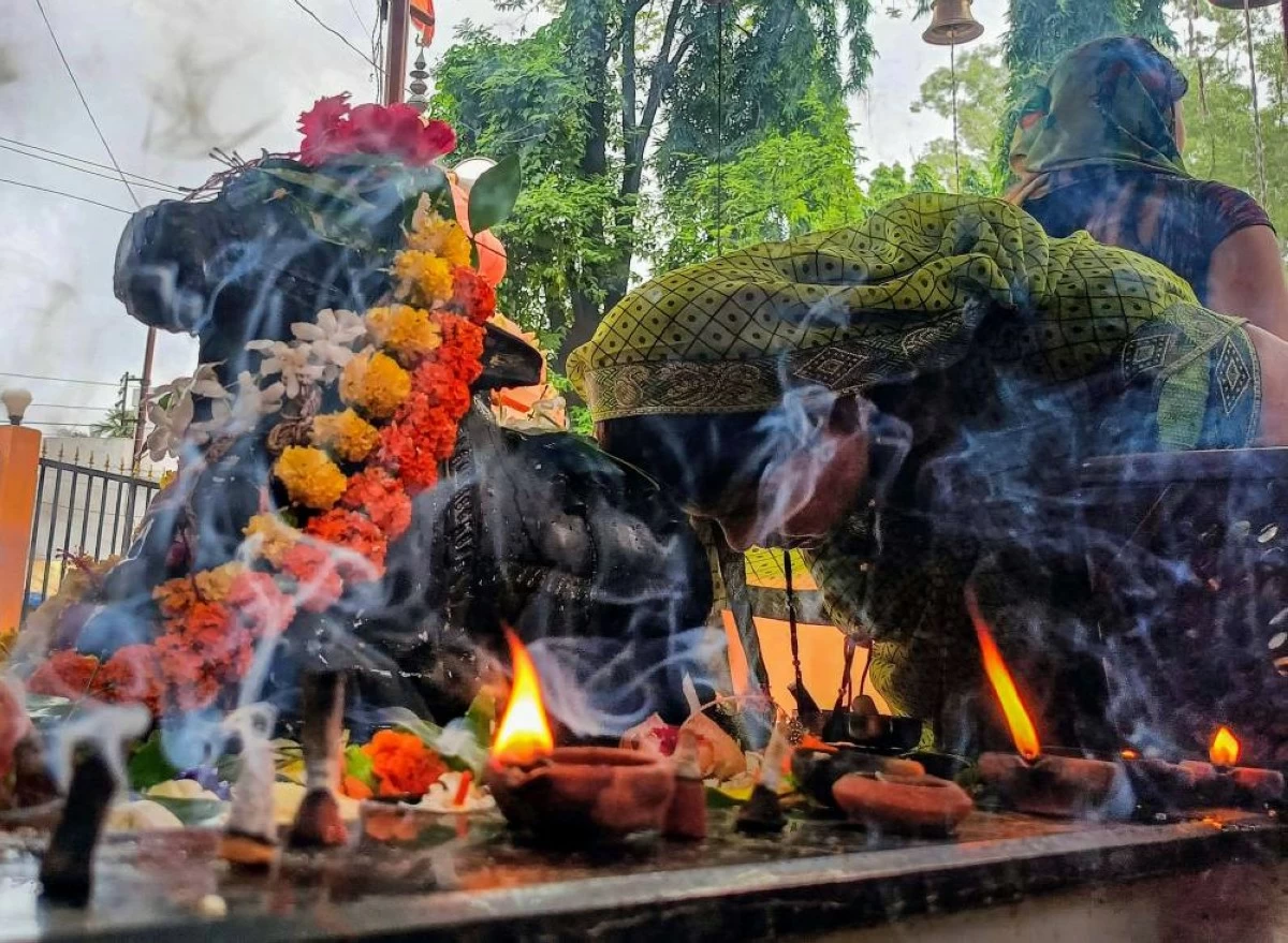 Devotee prays to 'Nandi' after worshipping Lord Shiva at Shiva temple in Jagdalpur of Bastar, Chhattisgarh
