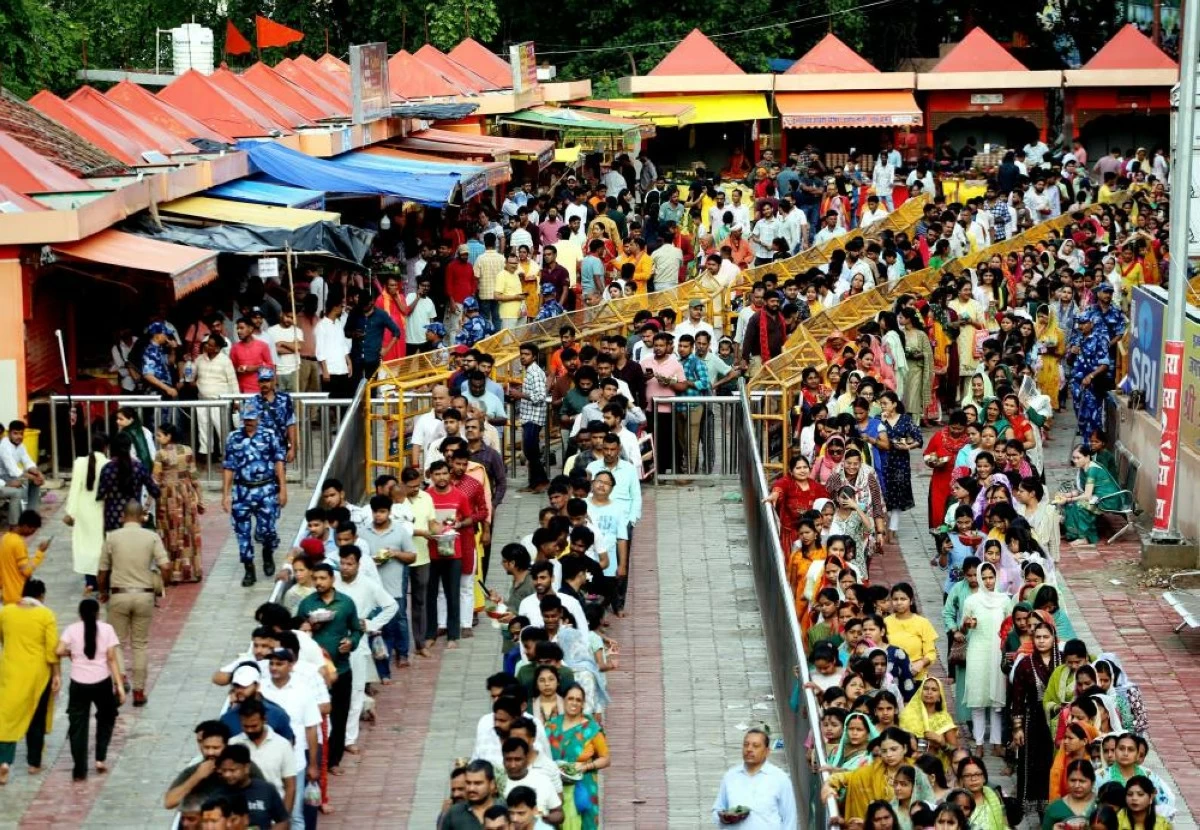 People stand in queues to offer prayers to Lord Shiva at Mankameshwar Temple in Prayagraj