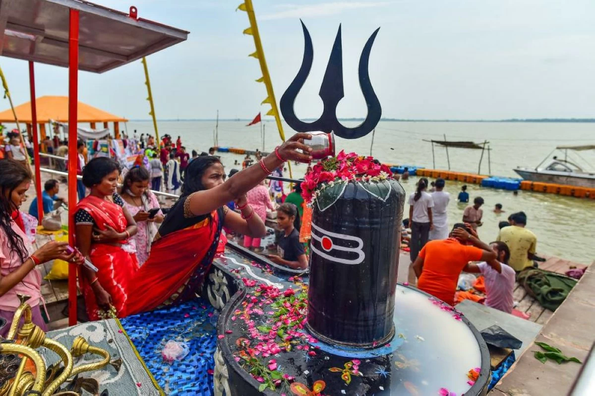 People offer prayers to Lord Shiva on the first Sawan Somwar at a ghat in Prayagraj