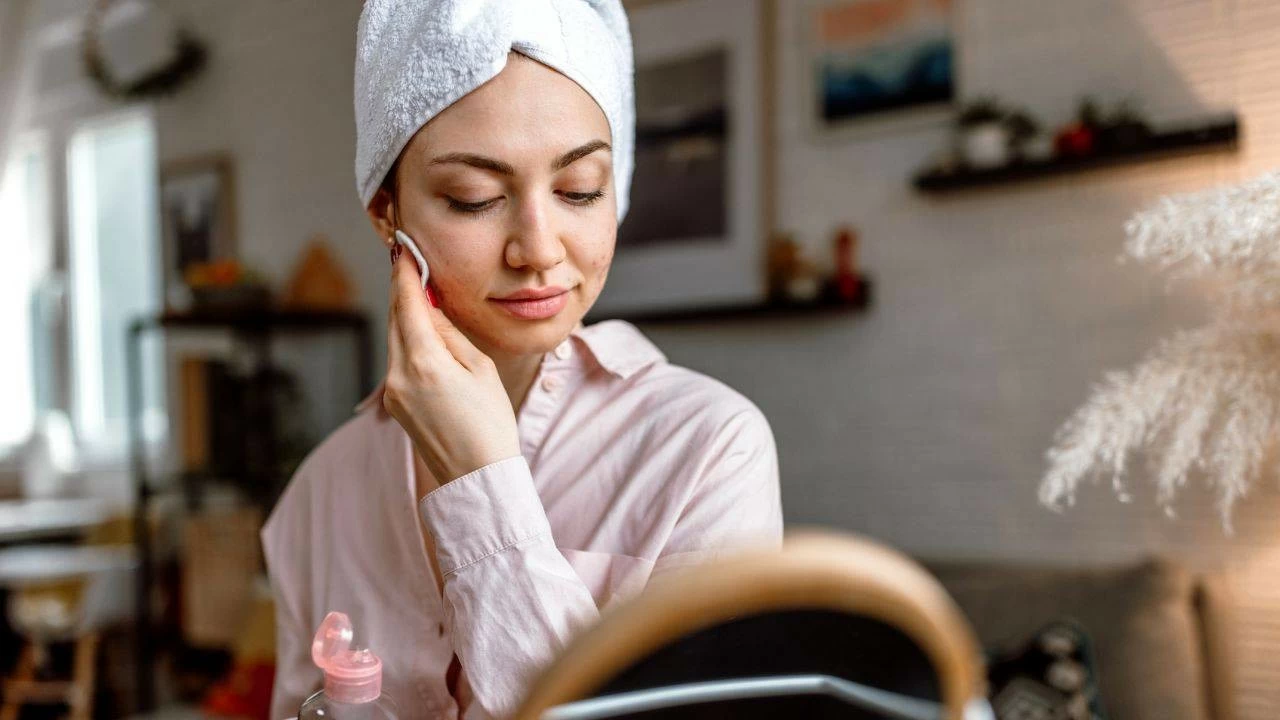 Woman uses face toner.