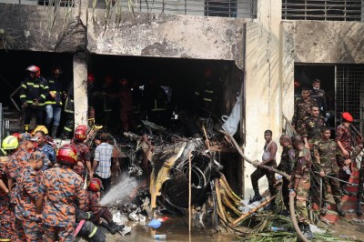 Members of the Bangladesh Army and the fire service start rescue operations after a Bangladesh Air Force F7 aircraft crashed into a building of Milestone College in Dhaka's Uttara around 1:30 pm on July 21, 2025 in Dhaka, Bangladesh.(Abdul Goni/Drik/Getty Images)