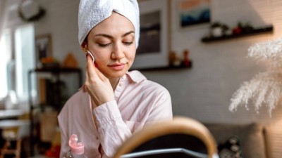 Woman uses face toner.