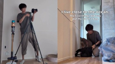 Japanese man evacuates home with pets following tsunami alert.