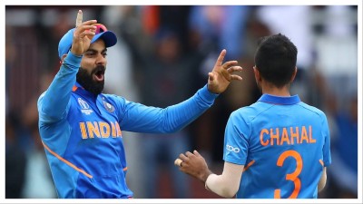 Virat Kohli congratulates Yuzvendra Chahal after dismissing Kane Williamson during the Semi-Final match of the ICC Cricket World Cup 2019.