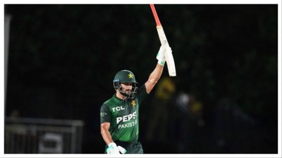 
Pakistan's Sahibzada Farhan raises his bat after reaching a half century during the third Twenty20 cricket match against the West Indies, Sunday, Aug. 3, 2025, in Lauderhill.