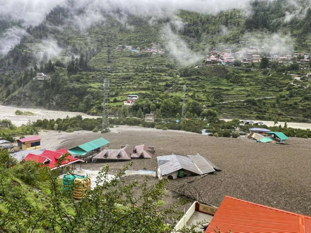Houses partially submerged following mudslide and flash floods triggered by a cloudburst at Kheer Gad area in Dharali of Uttarkashi district