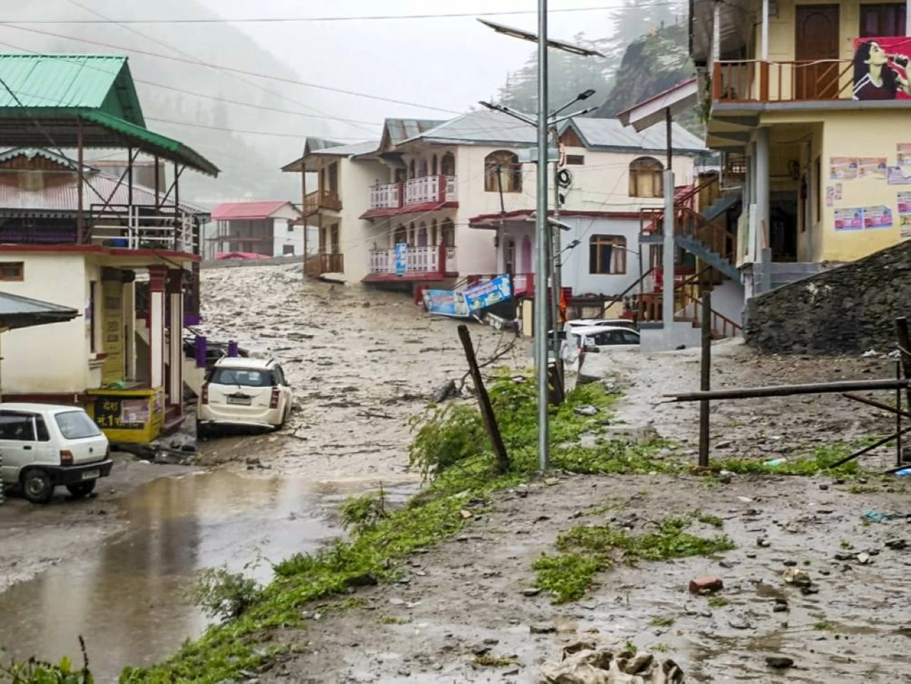 Houses partially submerged due to flash floods triggered by a cloudburst at Kheer Gad area in Dharali of Uttarkashi district