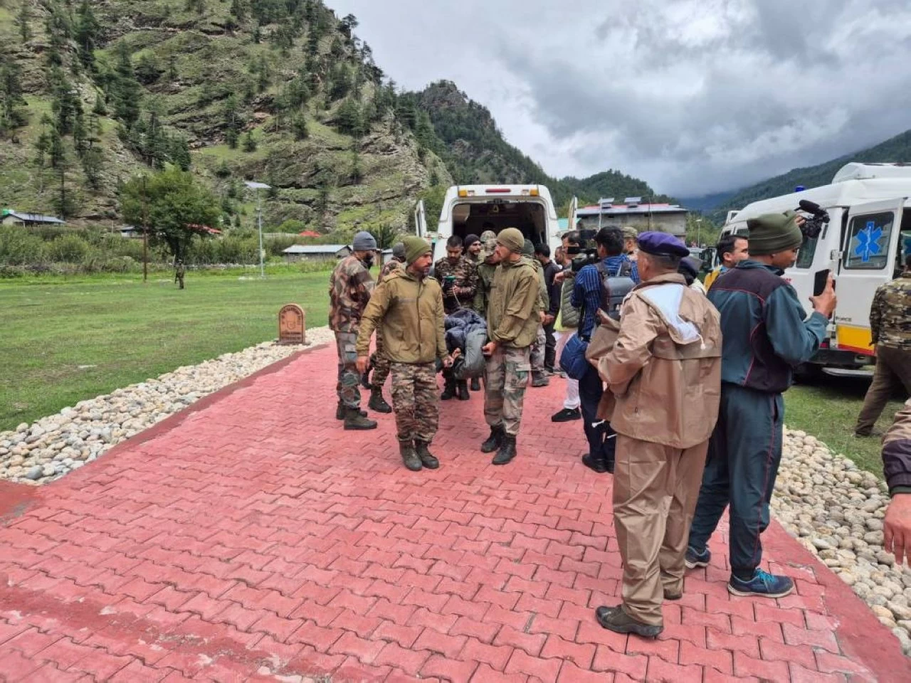 Rescue helicopters at Harsil prepare for airlifting stranded pilgrims. Army personnel continue rapid evacuation under tough conditions.