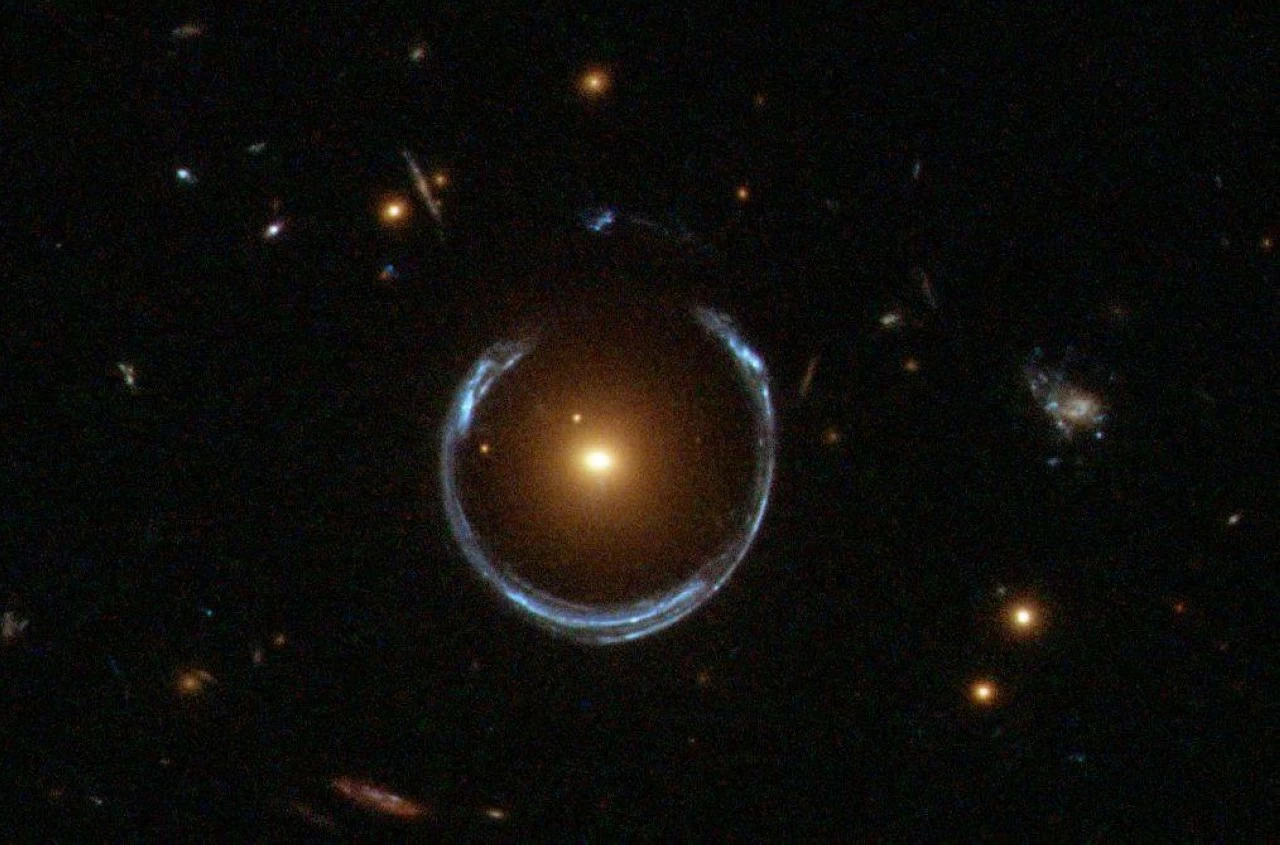 The black hole is located within the Cosmic Horseshoe galaxy, which also forms an Einstein Ring. 