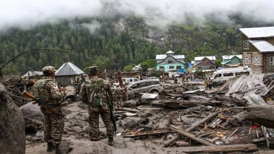 Security personnel stand amid the debris at an affected area following a cloudburst in Kishtwar district, Jammu and Kashmir, on Friday, Aug. 15, 2025. At least 60 people were killed and over 100 suffered injuries in the incident, according to officials.