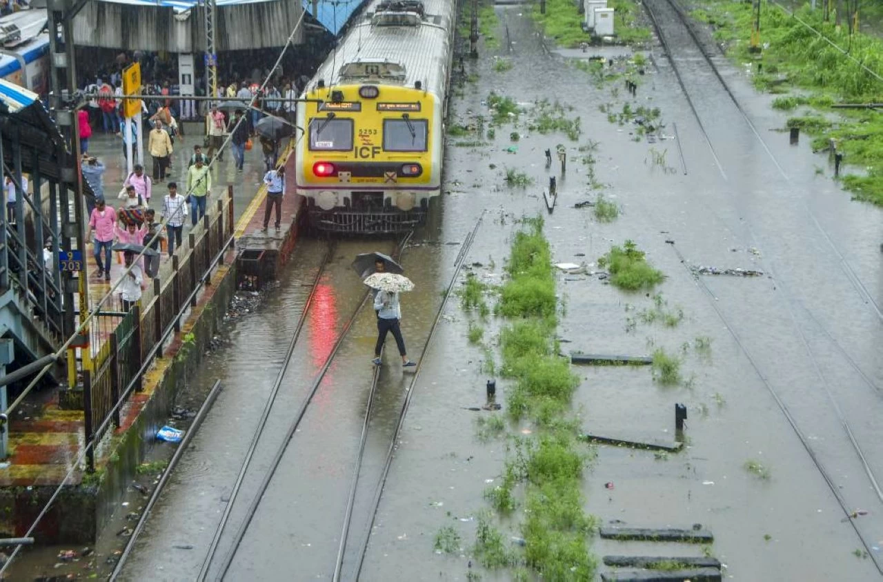 A Mumbai local train moves on partially submerged tracks on Monday. (PTI)