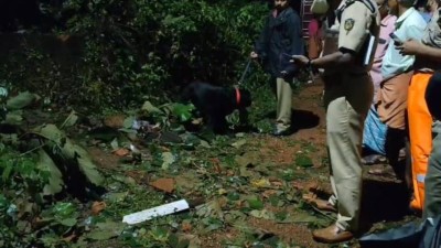 Police inspecting the nearby vicinity of the house that was flattened following an explosion that happened in Kannur