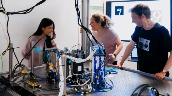 Jiaqi Chu, Francesca Parmigiani and James Clegg with the current model of Microsoft Research’s analog optical computer in Cambridge, U.K. Photo by Chris Welsch for Microsoft.