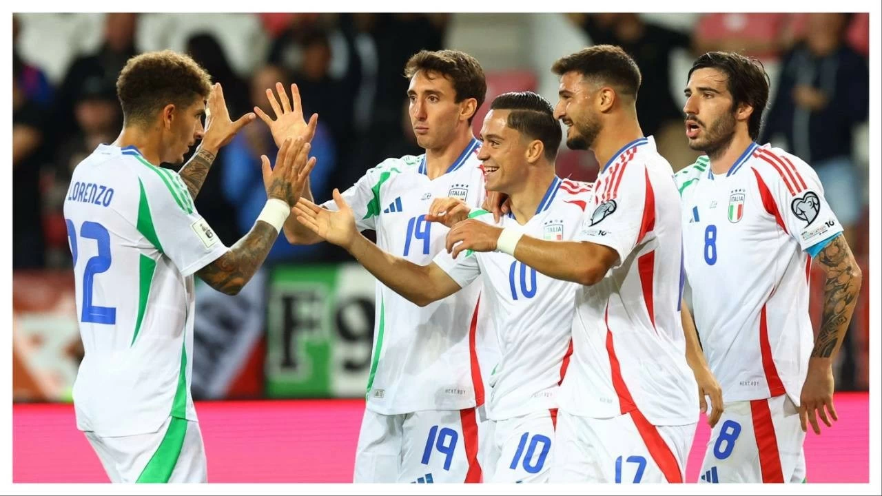 Italy players celebrate scoring against Israel.