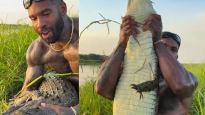 Man fearlessly grabs crocodile with bare hands in viral video.