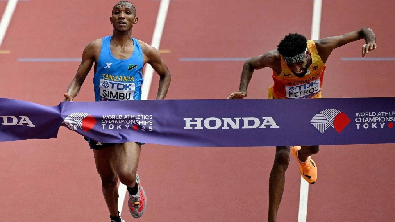World Athletics Championships Tokyo 2025 - Men's Marathon Final - Japan National Stadium, Tokyo, Japan - September 15, 2025 Tanzania's Alphonce Felix Simbu crosses the finish line to win the men's marathon final ahead of second-placed Germany's Amanal Petros.