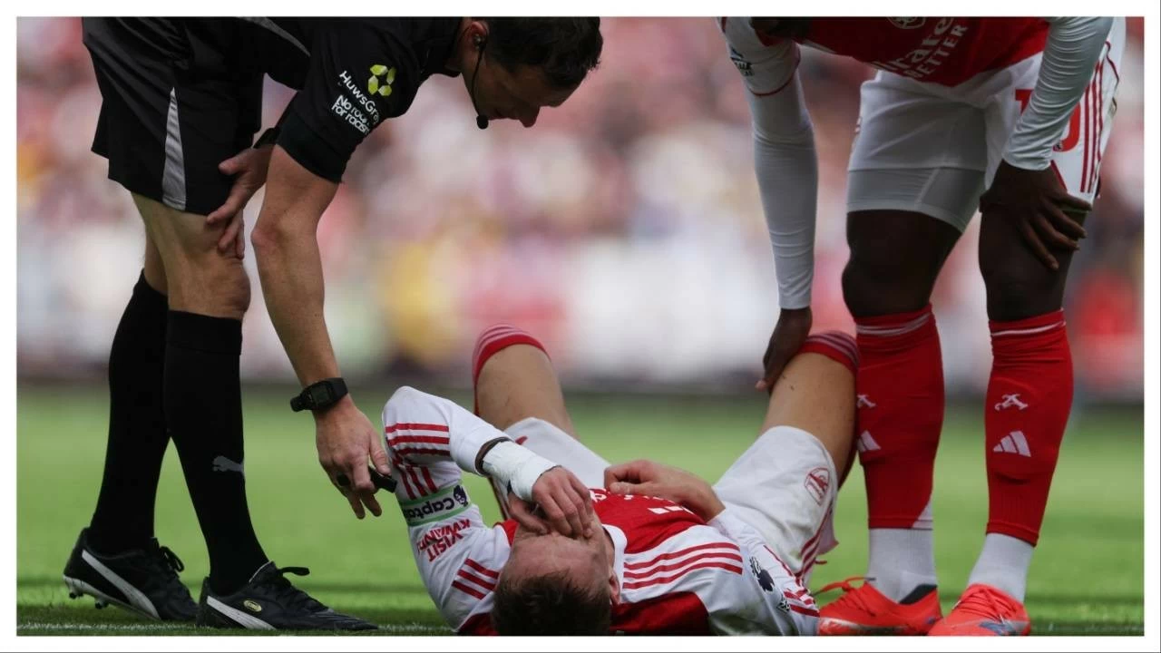Martin Odegaard down after sustaining an injury in Premier League match against Nottingham Forest. 