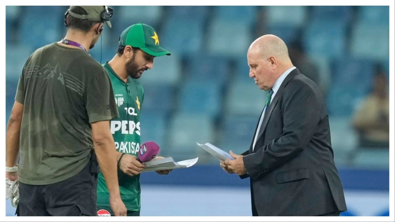 Pakistan&#039;s captain Salman Agha shares team list with match referee Andy Pycroft at the toss during their Asia Cup match against UAE on September 17.