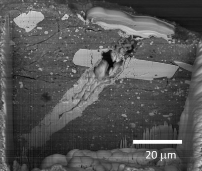 A scanning electron microscope image of a micrometeorite impact on samples returned from Asteroid Bennu. 