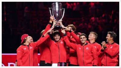 Team World player Taylor Fritz hoists the trophy with teammates after defeating Team Europe during the Laver Cup.