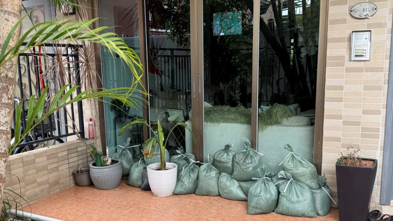 People pack up sandbags inside their households to prevent flooding from Super Typhoon Ragasa