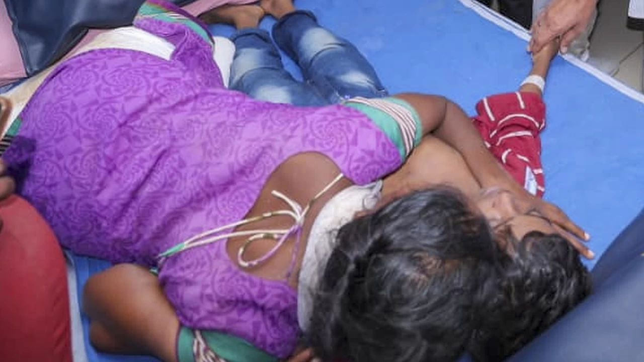 A family member breaks down as an injured undergoes treatment at a hospital after a stampede occurred at Karur, Tamil Nadu