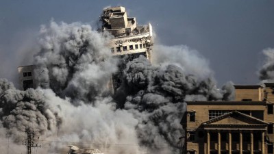 Smoke rises from the building following the Israeli army targeted a 7-story building known as the Al-Roya Tower with an airstrike in Gaza City, Gaza.