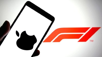 In this photo illustration, an Apple logo is seen displayed on a smartphone with a Formula 1 (F1) logo in the background. 