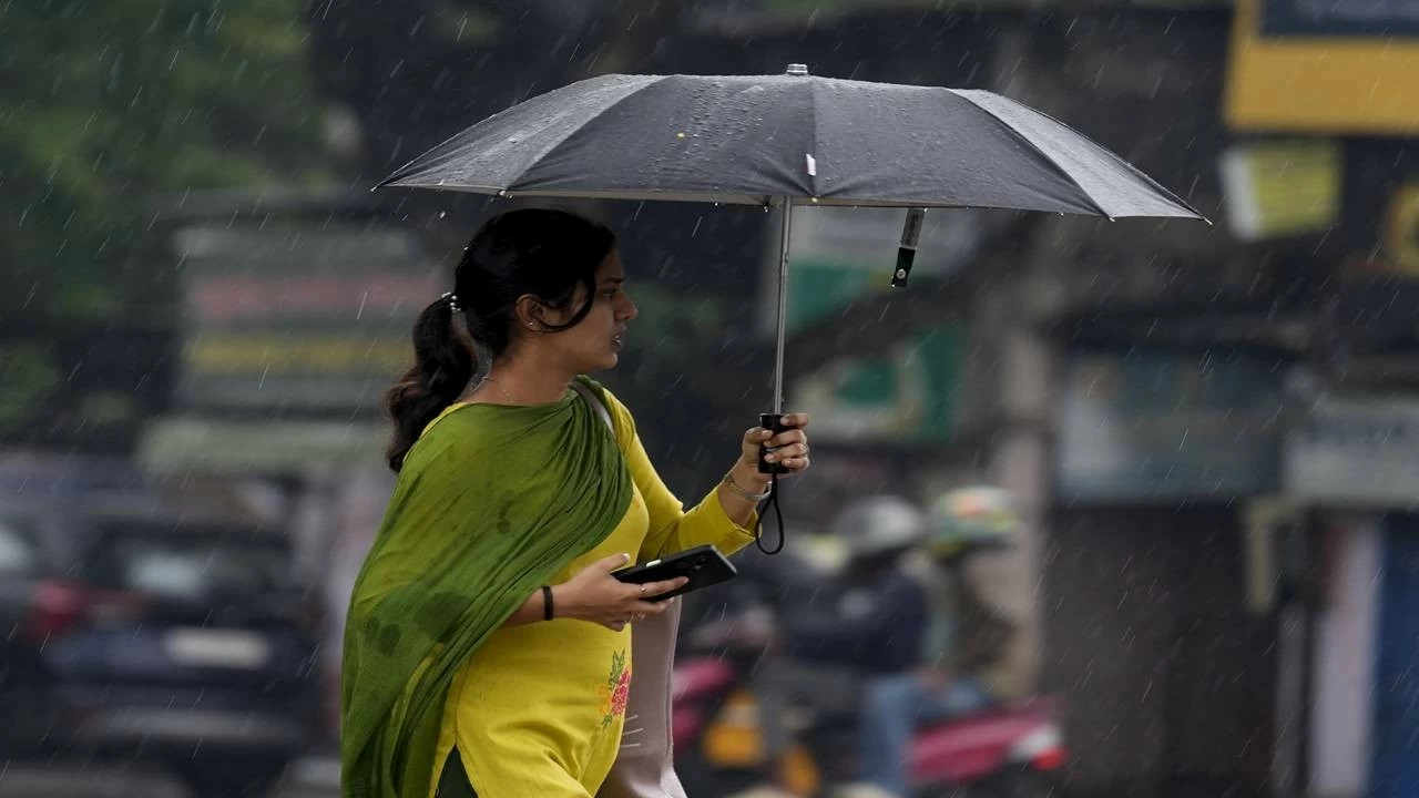 A woman makes her way through rain triggered by Cyclone Montha, in Chennai, Tamil Nadu, Monday, Oct. 27, 2025. (PTI Photo)