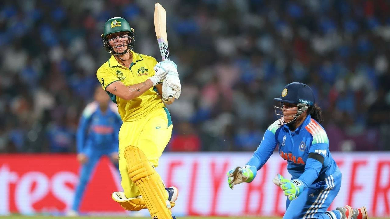 
Ash Gardner of Australia bats as wicket keeper Richa Ghosh of India looks on during the ICC Women&#039;s Cricket World Cup India 2025 Semi-Final match between India and Australia at DY Patil Stadium on October 30, 2025 in Navi Mumbai, India