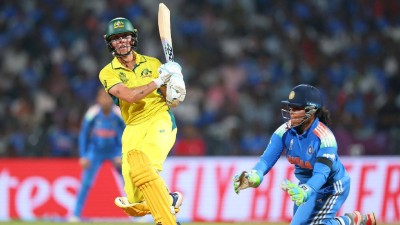 
Ash Gardner of Australia bats as wicket keeper Richa Ghosh of India looks on during the ICC Women's Cricket World Cup India 2025 Semi-Final match between India and Australia at DY Patil Stadium on October 30, 2025 in Navi Mumbai, India