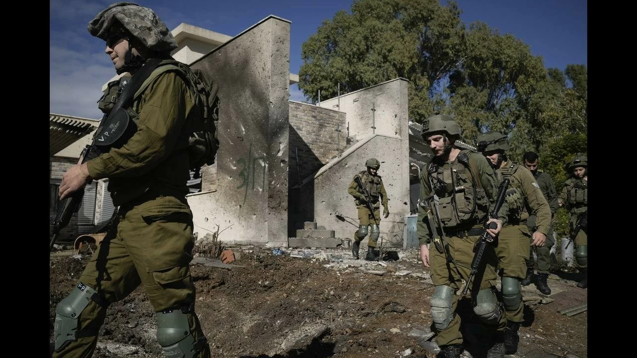Israeli soldiers inspect the site where a rocket fired from Lebanon landed in a backyard in Kiryat Shmona, northern Israel.