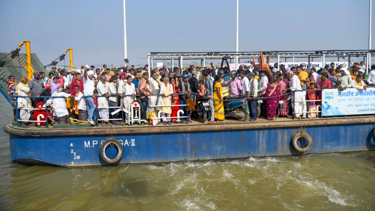 Voters onboard a ferry to cross the Ganga river before casting their votes during the first phase of the Bihar Assembly elections, at Danapur in Patna on November 6. (Photo credit: PTI)