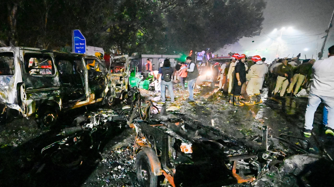Charred remains of vehicles and glass scattered on the road at the blast spot  (PTI)
