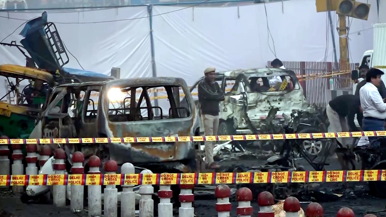 Charred remains of vehicles amid a cordoned off area following a blast that occurred near Red Fort Metro Station on Monday. (Photo credit: PTI)