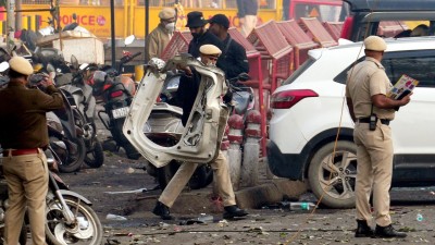 Police personnel at the site in the aftermath of the blast that occurred near Red Fort Metro Station on Monday