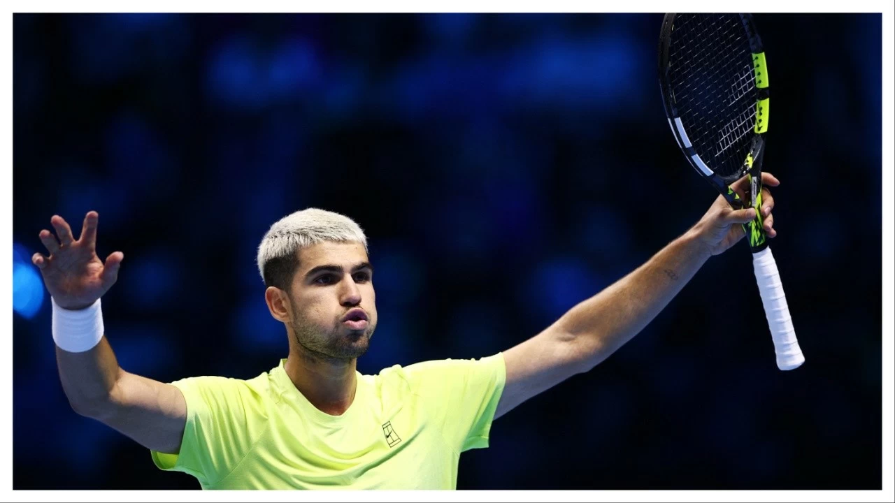 Carlos Alcaraz celebrates after winning his group stage match against Taylor Fritz.
