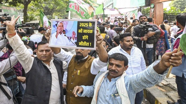 JD (U) supporters celebrate as the NDA leads during the counting of votes of the Bihar Assembly elections, in Patna, on Friday, Nov. 14, 2025. (PTI Photo)