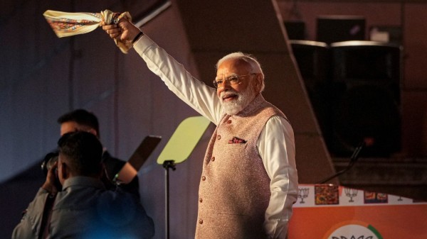 Prime Minister Narendra Modi waves a gamcha as he arrives during the celebration of NDAs victory in the Bihar assembly elections, at BJP headquarters in New Delhi on Friday