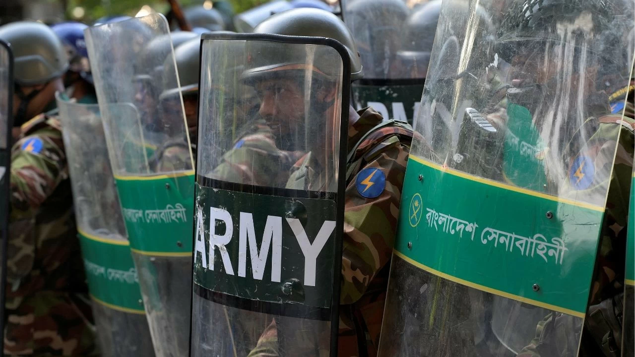  Army soldiers cover themselves with shields during a protest demanding demolition of the house of Bangabandhu Sheikh Mujibur Rahman, father of the ousted Prime Minister Sheikh Hasina, after the verdict on cases against Sheikh Hasina, in Dhaka, Bangladesh. 