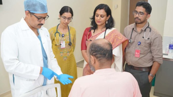 Gastro Surgeon Dr. Joseph George shows the patient the fish bone removed from the liver through surgery. Senior Consultant of the General Medicine department, Dr. Salini Baby John, is nearby, at Rajagiri Hospital, Aluva.