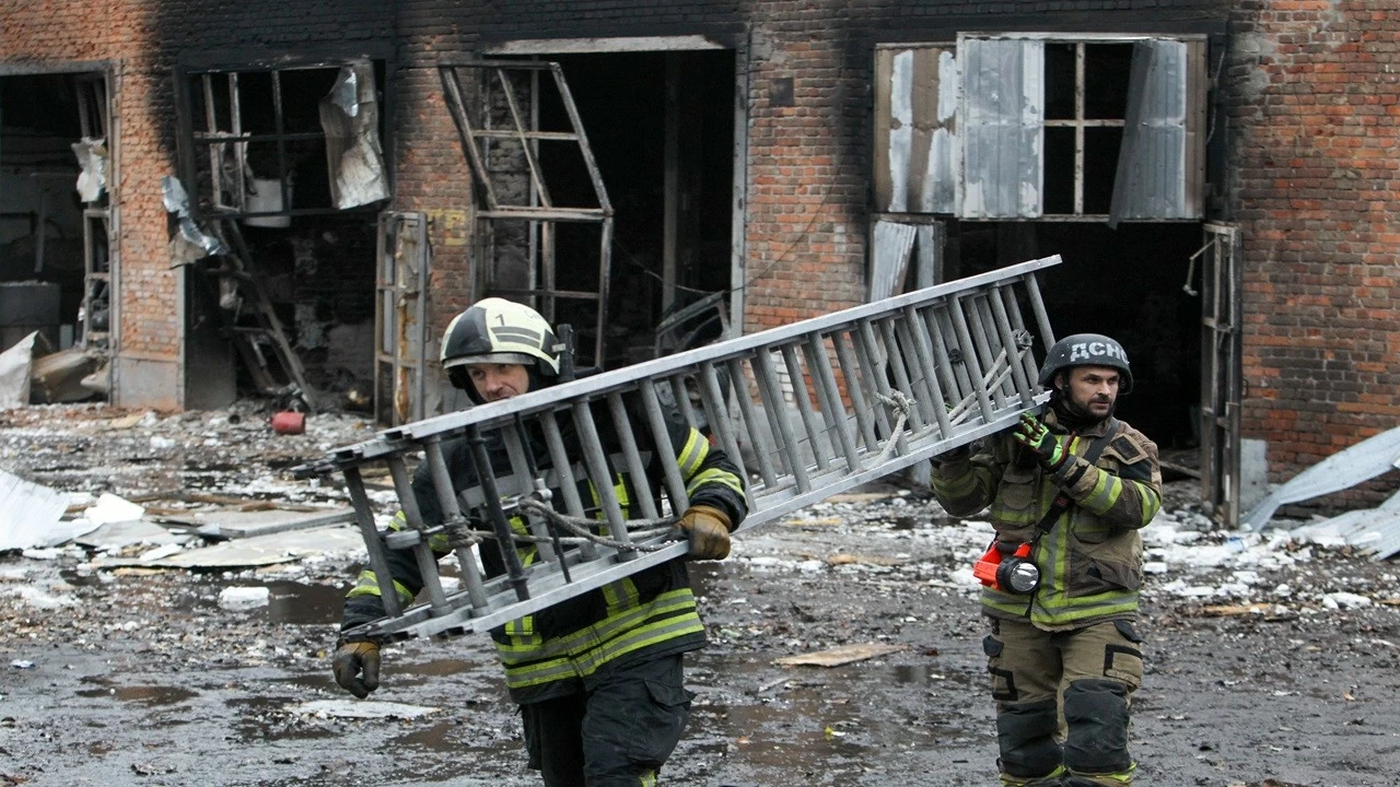 Firefighters carry a ladder during a response effort to a large-scale overnight Russian drone attack in Dnipro, Ukraine, on November 18, 2025. (Photo: Getty Images)