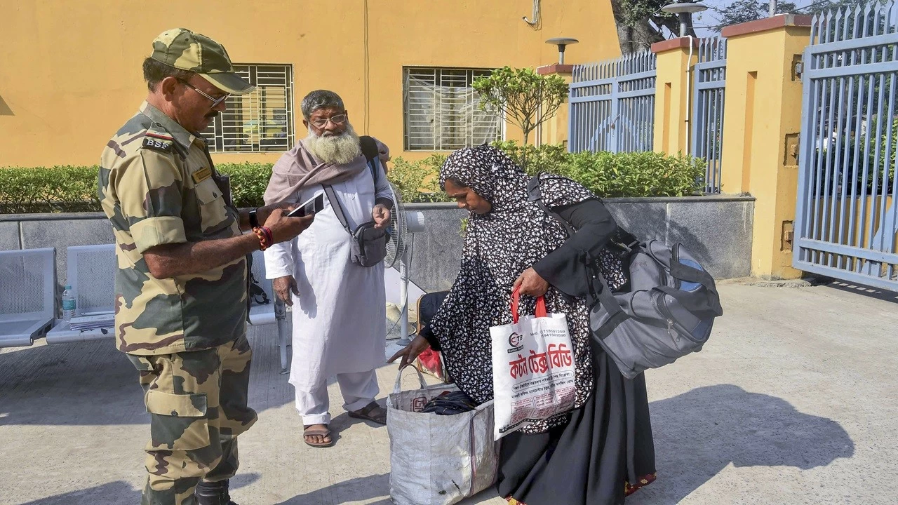 A BSF official checks credentials of Bangladeshi citizens returning to their country at the India-Bangladesh Border, at Petrapole, in North 24 Parganas district, (Photo: PTI)