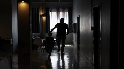 A Palestinian man, one of 130 granted entry to South Africa after initially being denied for not meeting immigration requirements, walks with his child to an undisclosed location in Johannesburg, South Africa, on November 14, 2025. (Photo Reuters)