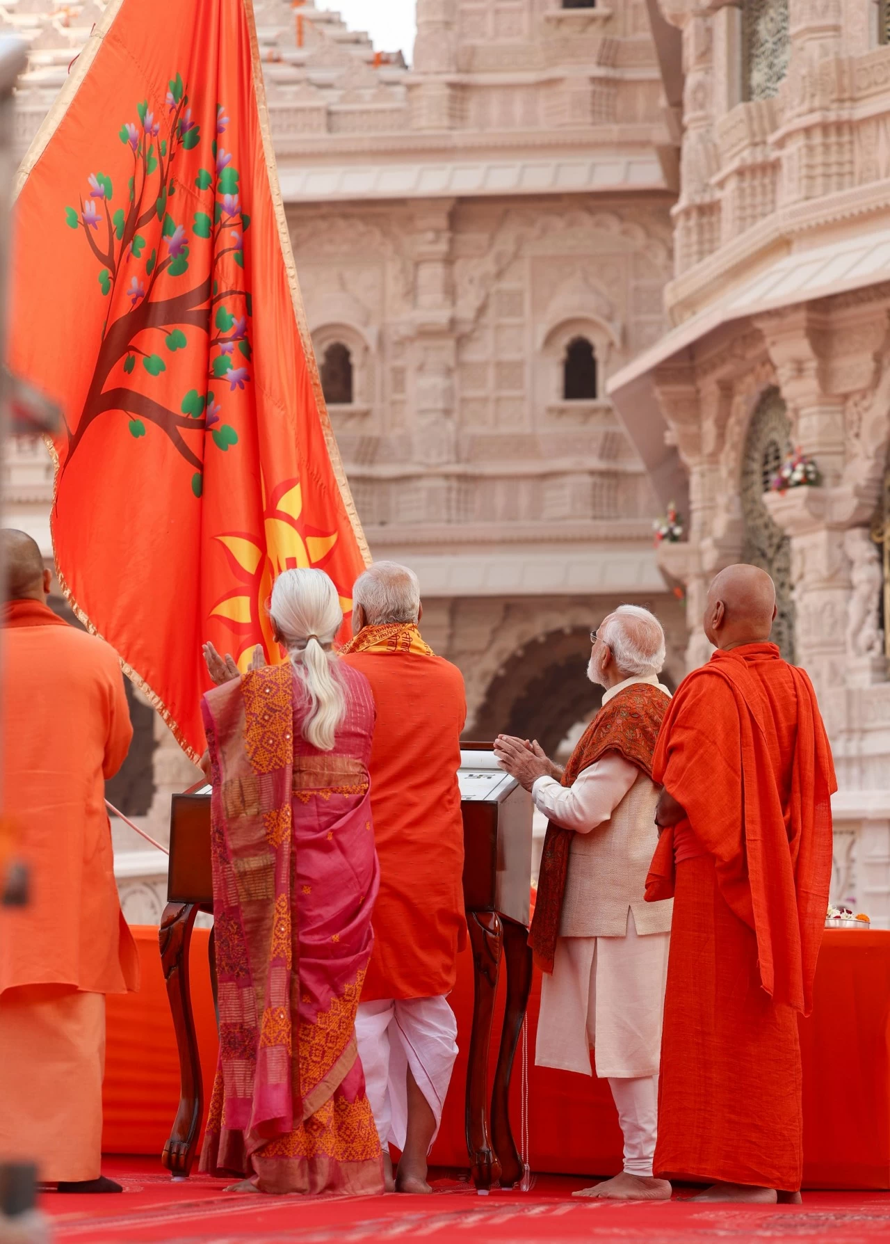 The sacred flag bears the image of a radiant sun symbolising the 'Surya Vansh' of Lord Rama, with an 'Om' inscribed on it 