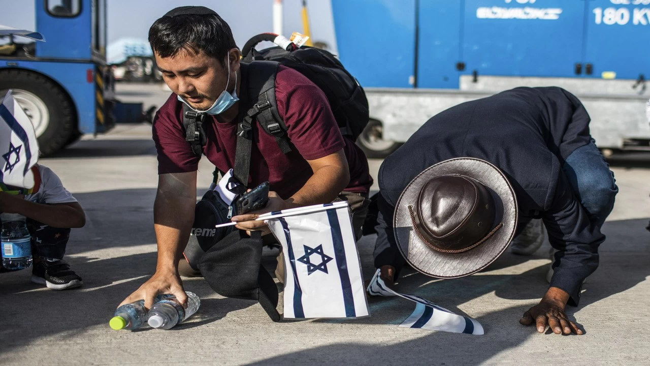 New Jewish emigrants from the Bnei Menashe (sons of Manasseh) community in India, kneel to the ground as they cheer after arriving at Ben Gurion Airport near Tel-aviv.
